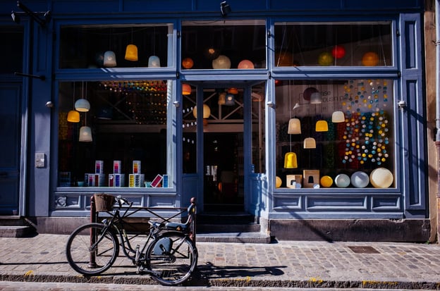 A bike rests outside a small store.