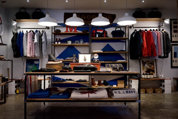 Racks and shelves are neatly arrayed with a selection of colorful men's clothing.